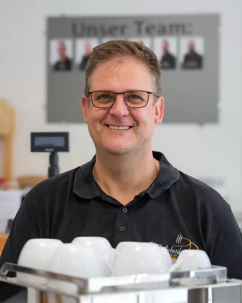 T. Acker, owner of Kaffeetechnik Acker, in his shop